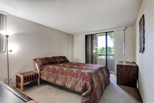 carpeted bedroom featuring access to outside and a textured ceiling