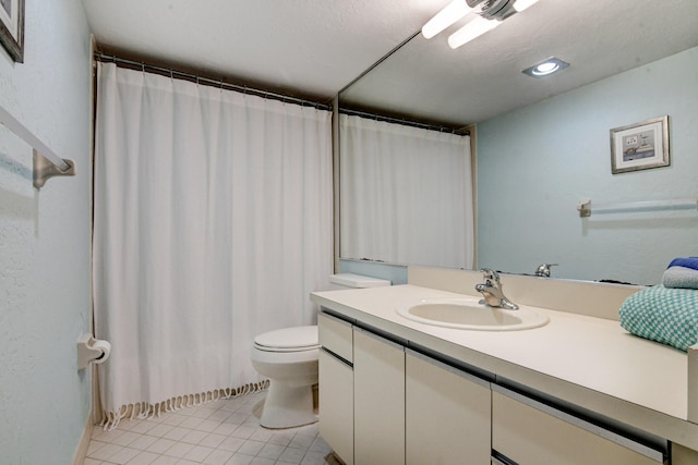 bathroom featuring tile patterned flooring, vanity, and toilet