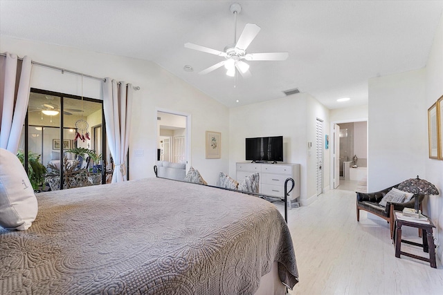 bedroom featuring vaulted ceiling, ensuite bath, access to exterior, ceiling fan, and light wood-type flooring