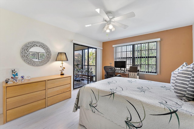 bedroom featuring multiple windows, access to exterior, ceiling fan, and light wood-type flooring