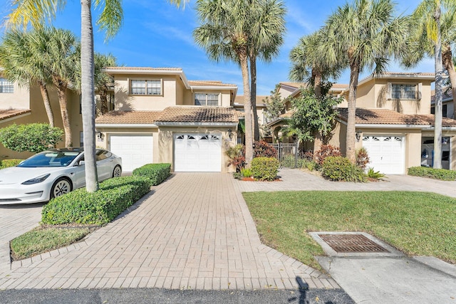 mediterranean / spanish-style home with a garage and a front yard