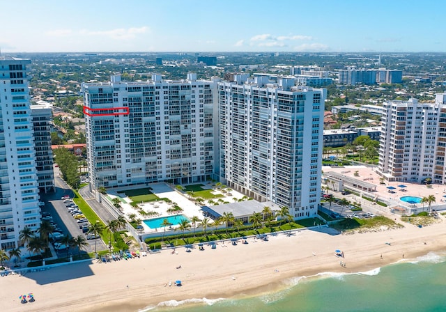 drone / aerial view featuring a view of the beach and a water view