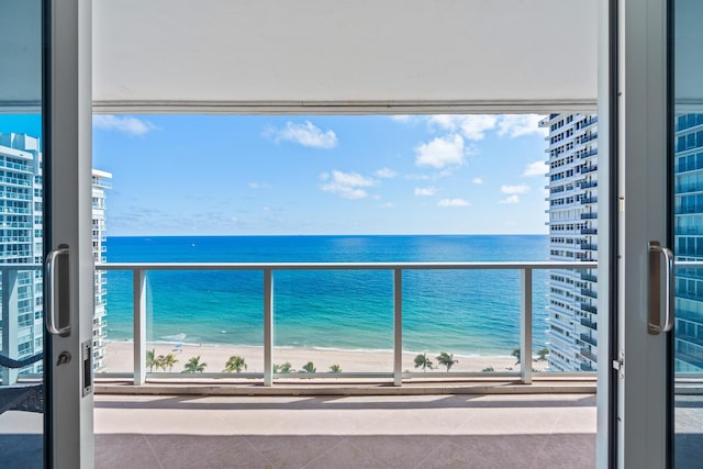 balcony with a water view and a beach view