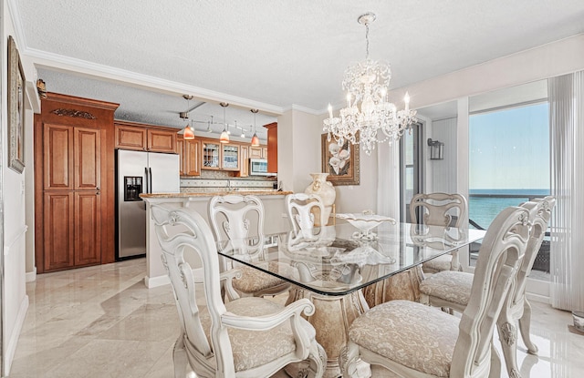 dining area with an inviting chandelier, crown molding, a textured ceiling, and a water view