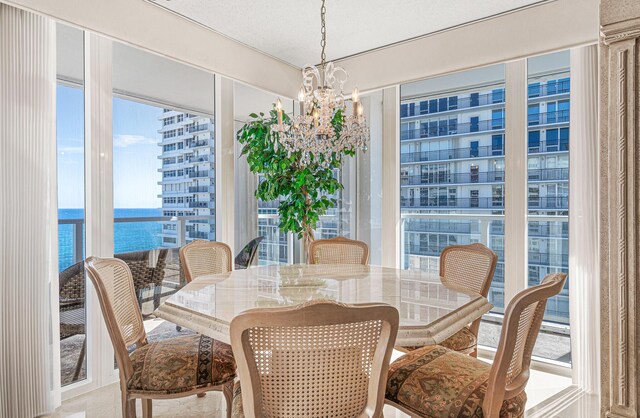 dining area with a notable chandelier and a water view