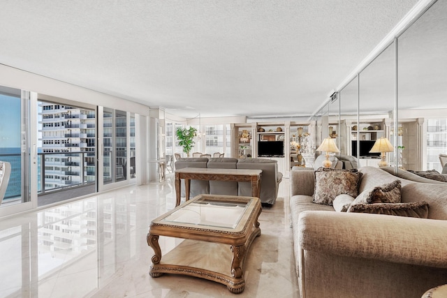 living room with a water view, floor to ceiling windows, and a textured ceiling