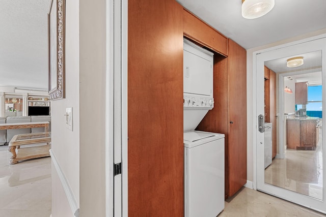 laundry room featuring stacked washer and dryer