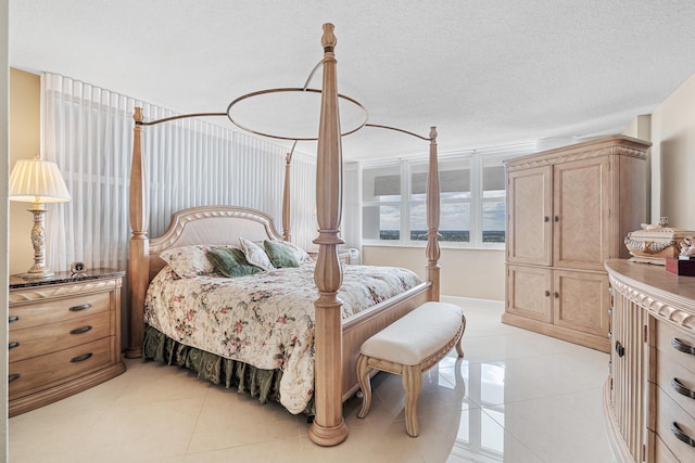 bedroom with light tile patterned floors and a textured ceiling