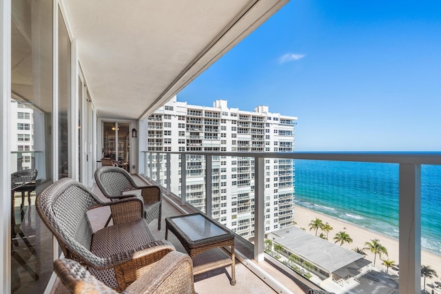 balcony with a view of the beach and a water view