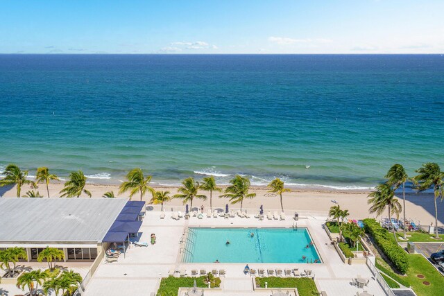 view of pool featuring a water view and a patio