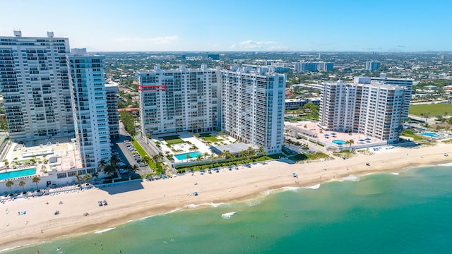 birds eye view of property with a view of the beach and a water view