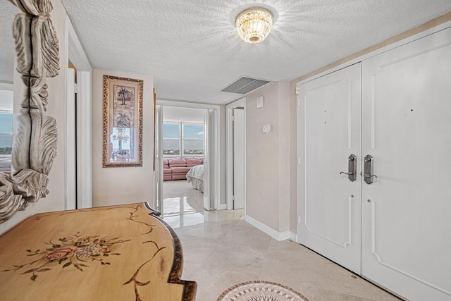 foyer with a textured ceiling