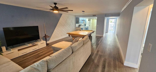 living room featuring ceiling fan, ornamental molding, and dark hardwood / wood-style flooring