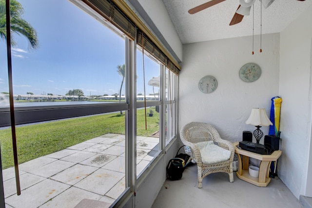 sunroom / solarium featuring ceiling fan