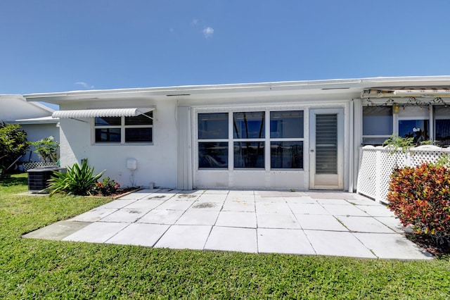 rear view of house featuring cooling unit and a patio