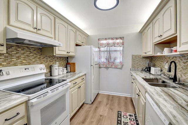 kitchen with sink, tasteful backsplash, light hardwood / wood-style flooring, white appliances, and cream cabinets