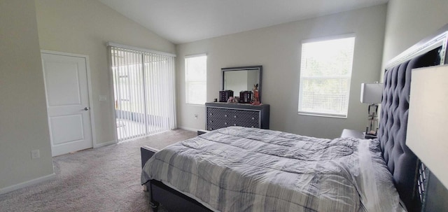 bedroom with vaulted ceiling and light colored carpet