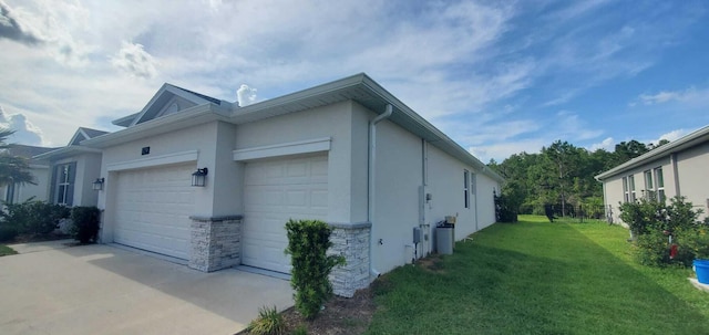 view of side of home with a garage and a yard