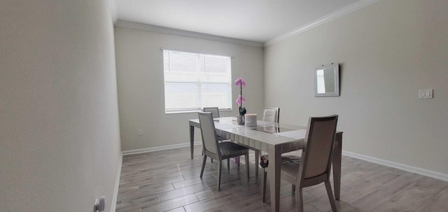 dining room featuring hardwood / wood-style flooring and ornamental molding