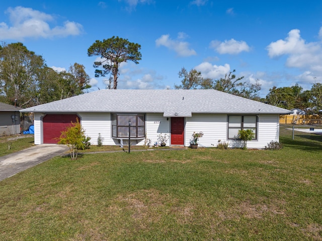 ranch-style home featuring a garage and a front lawn