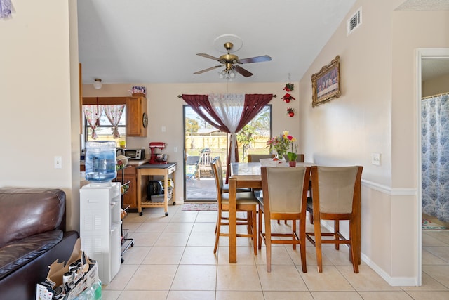 tiled dining space with ceiling fan