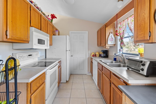 kitchen featuring sink, white appliances, vaulted ceiling, and light tile patterned floors