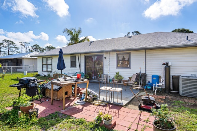 rear view of house with cooling unit and a patio area