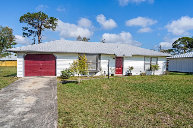 ranch-style home with a garage and a front lawn