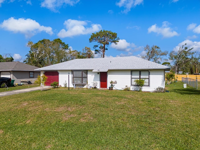 single story home featuring a garage and a front lawn