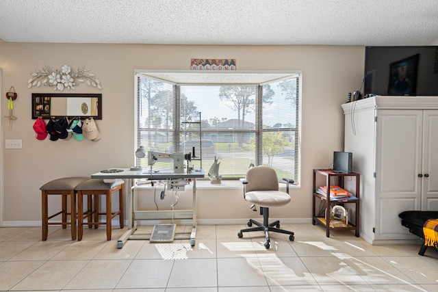 home office with a textured ceiling and light tile patterned flooring