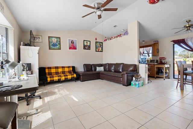 living room with light tile patterned flooring, lofted ceiling, and ceiling fan