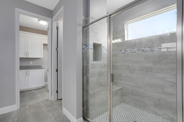 bathroom featuring tile patterned flooring and a shower with door