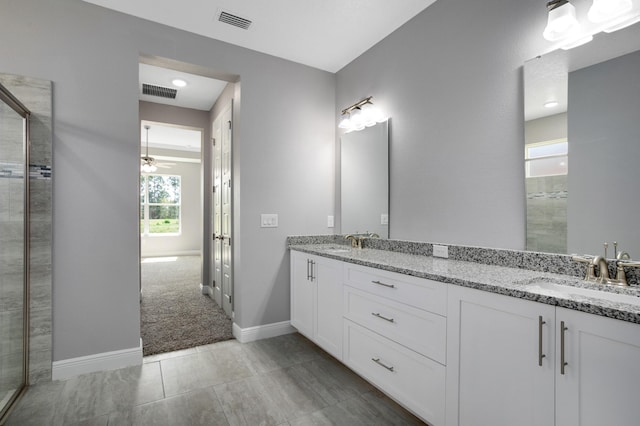 bathroom with ceiling fan and vanity