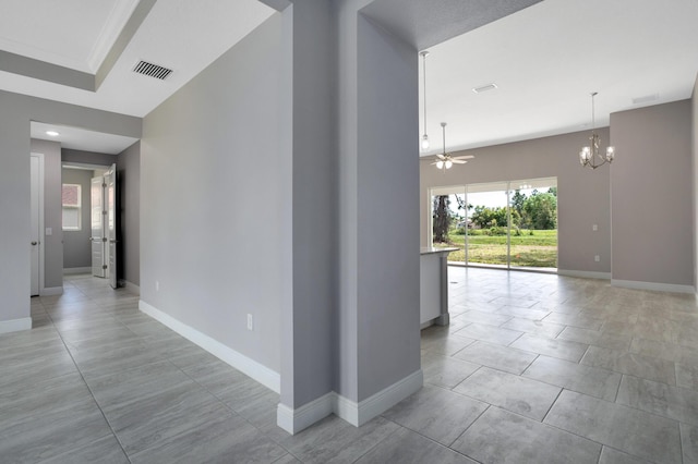 hallway featuring an inviting chandelier and light tile patterned floors