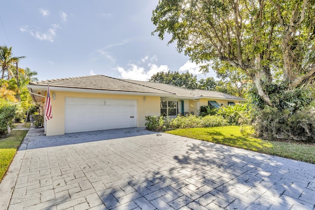 ranch-style house with a garage and a front yard