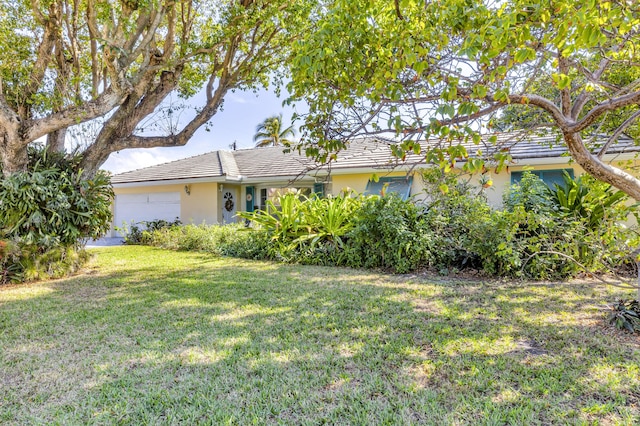 view of front of house with a garage and a front yard