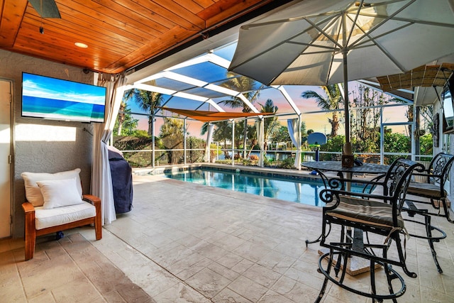 view of pool with a lanai and a patio area