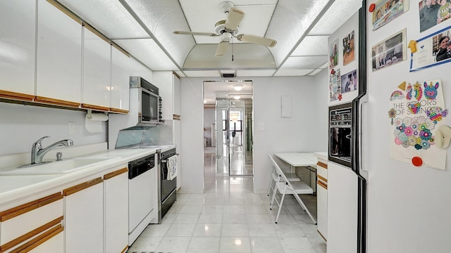 kitchen featuring sink, white appliances, white cabinets, and ceiling fan