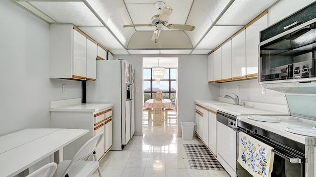 kitchen featuring white cabinetry, dishwasher, sink, white refrigerator with ice dispenser, and ceiling fan