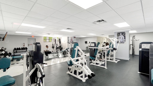 gym with a paneled ceiling