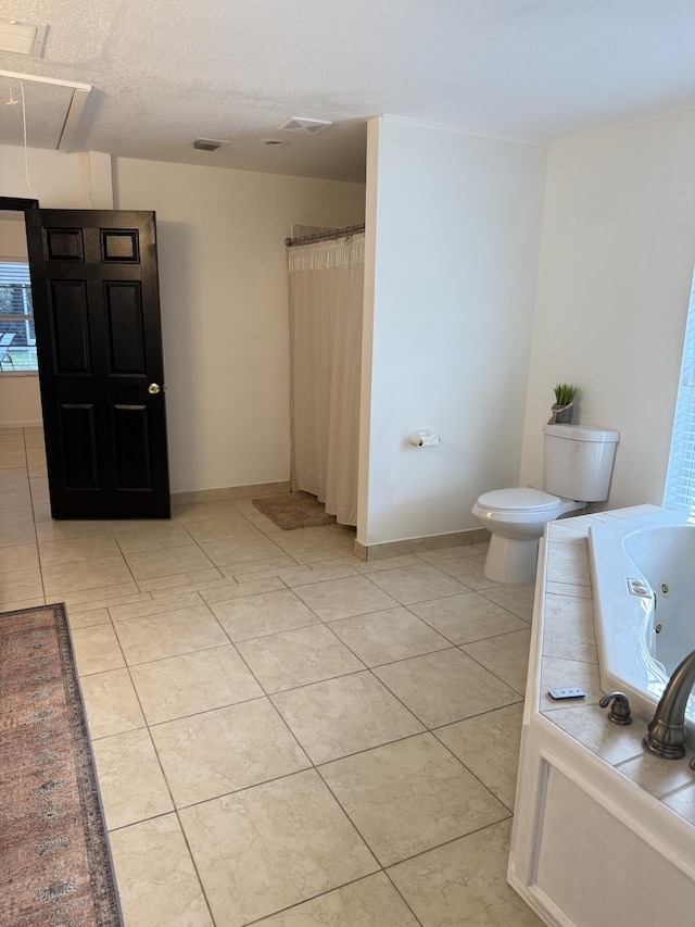 bathroom with toilet, tile patterned flooring, and a tub