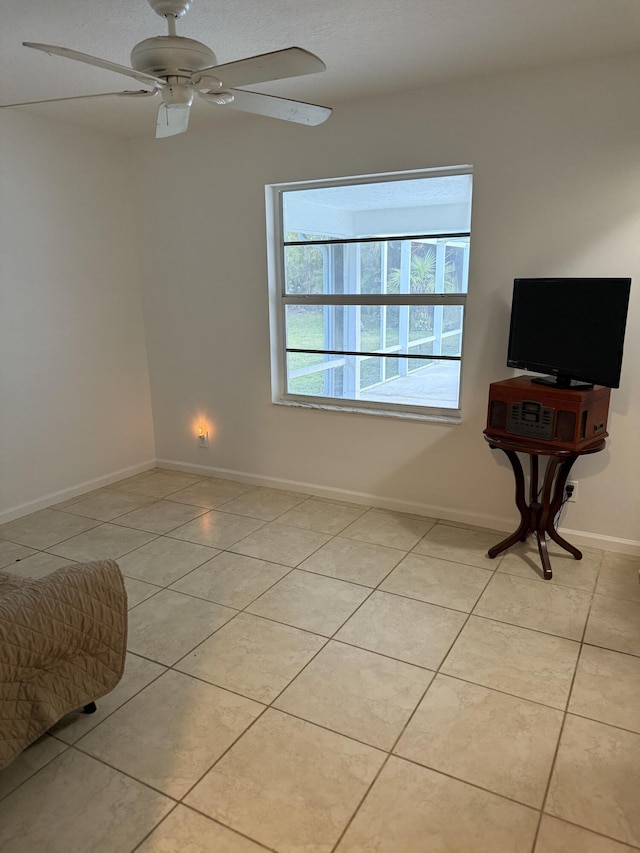 spare room with light tile patterned floors and ceiling fan