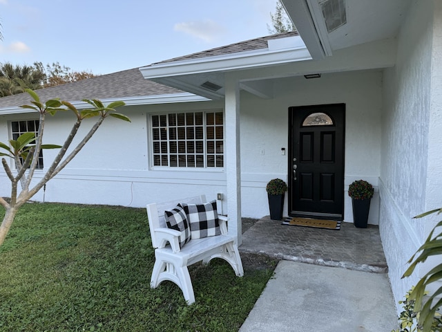 property entrance with a yard