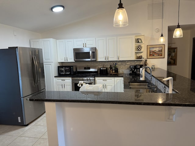 kitchen with white cabinetry, kitchen peninsula, and appliances with stainless steel finishes