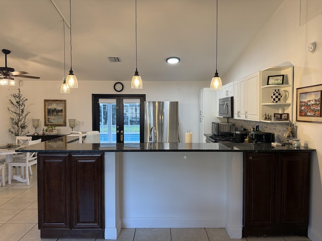 kitchen featuring stainless steel appliances, vaulted ceiling, pendant lighting, and backsplash