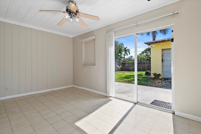 tiled empty room featuring ornamental molding and ceiling fan