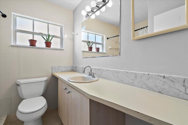 bathroom with vanity, tile walls, a shower with shower curtain, and toilet