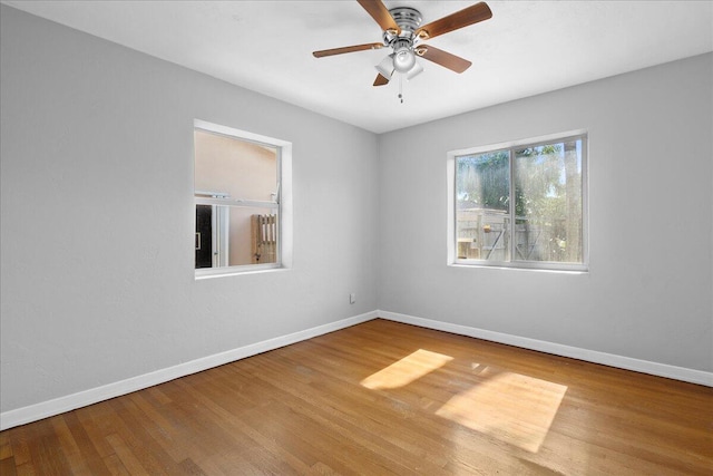 empty room featuring hardwood / wood-style floors and ceiling fan