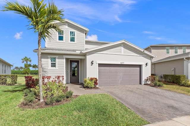 view of front facade with a garage and a front yard