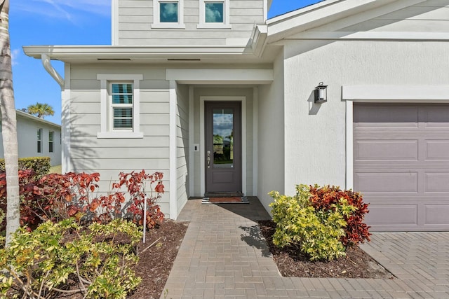 view of exterior entry with a garage